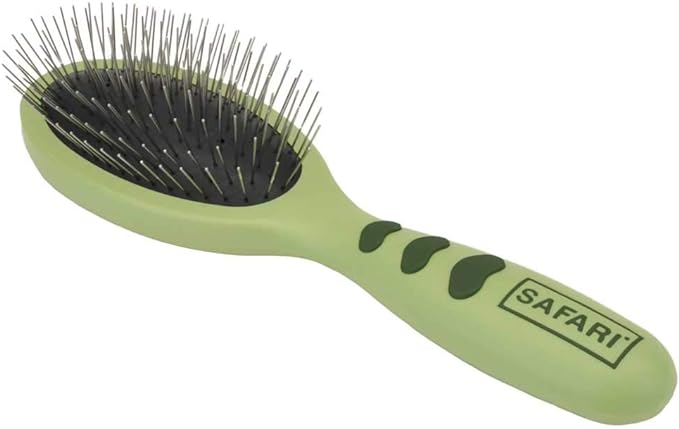 A green safari brush, perfect for grooming yorkie puppies.